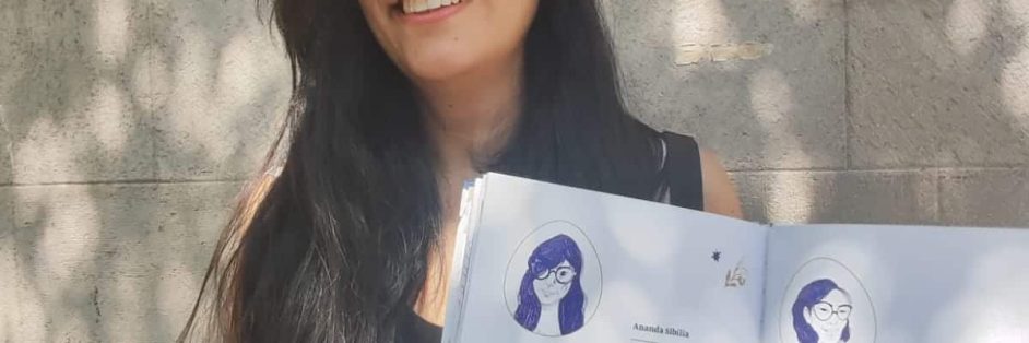 Una mujer de pelo largo sostiene un libro abierto. Es la autora de Refugio, libro ilustrado de poemas